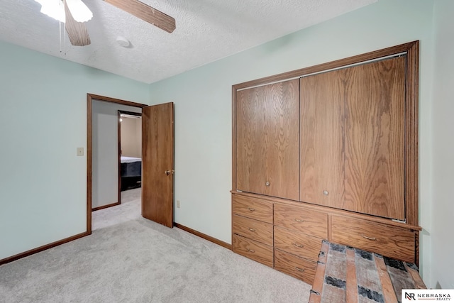 7105 W Davey Rd, Raymond, NE 68428 - unfurnished bedroom featuring light colored carpet, baseboards, a textured ceiling, and a ceiling fan