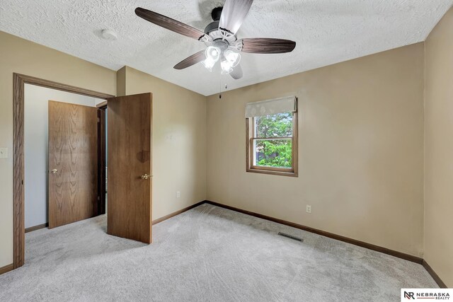 7105 W Davey Rd, Raymond, NE 68428 - unfurnished bedroom featuring carpet floors, baseboards, a textured ceiling, and ceiling fan