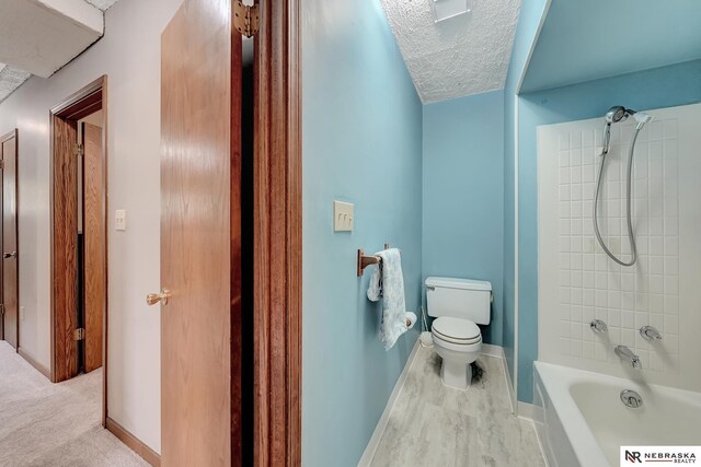 7105 W Davey Rd, Raymond, NE 68428 - full bathroom with toilet, bathtub / shower combination, a textured ceiling, and baseboards