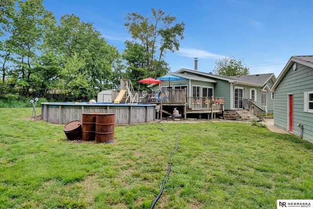 7105 W Davey Rd, Raymond, NE 68428 - view of grassy yard with a wooden deck and an outdoor pool