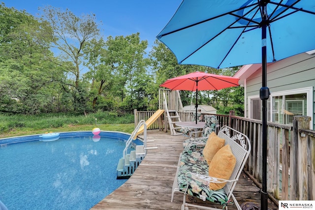 7105 W Davey Rd, Raymond, NE 68428 - swimming pool featuring a wooden deck and view of scattered trees