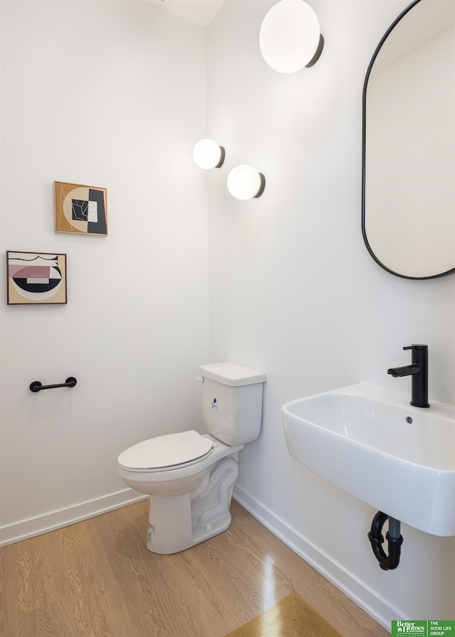 5320 Elmwood Plz, Omaha, NE 68106 - bathroom featuring baseboards, toilet, wood finished floors, and a sink