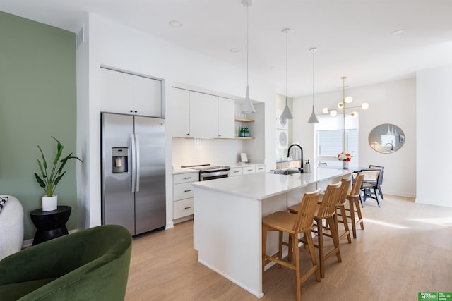 5320 Elmwood Plz, Omaha, NE 68106 - kitchen featuring stainless steel fridge with ice dispenser, light wood-type flooring, a sink, a kitchen bar, and light countertops