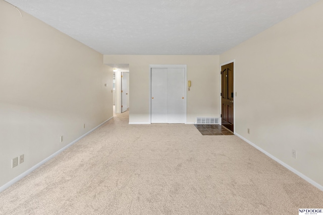 12726 Gail Plz Unit 107, Omaha, NE 68137 - unfurnished bedroom featuring carpet floors, baseboards, a closet, and a textured ceiling