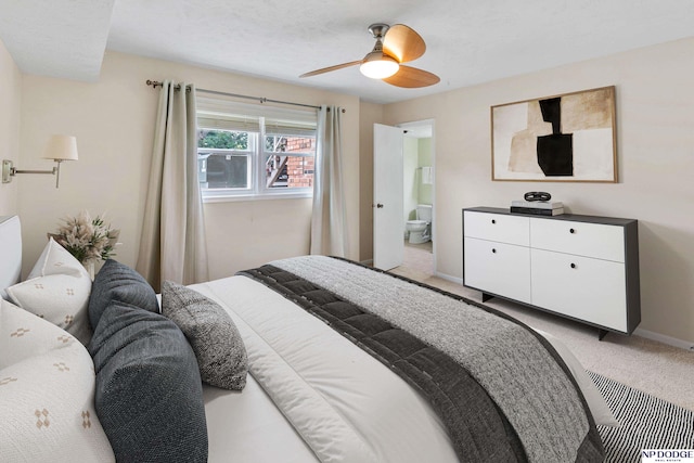 12726 Gail Plz Unit 107, Omaha, NE 68137 - bedroom with light carpet, baseboards, connected bathroom, and a ceiling fan
