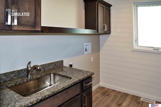 512 Deep Water Bay, Lincoln, NE 68527 - washroom featuring hookup for an electric dryer, washer hookup, cabinet space, baseboards, and dark wood-style floors