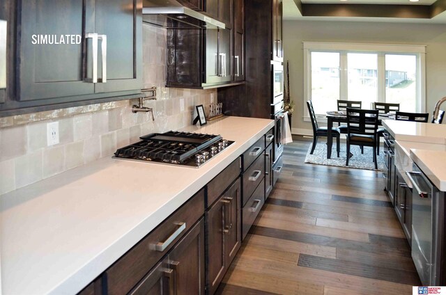 512 Deep Water Bay, Lincoln, NE 68527 - kitchen featuring appliances with stainless steel finishes, light countertops, dark brown cabinets, and a sink
