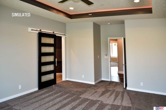 512 Deep Water Bay, Lincoln, NE 68527 - unfurnished bedroom featuring a raised ceiling, a barn door, carpet floors, recessed lighting, and baseboards