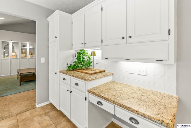 17310 I St, Omaha, NE 68135 - kitchen with light colored carpet, white cabinets, light stone counters, tasteful backsplash, and baseboards