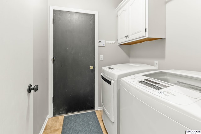 17310 I St, Omaha, NE 68135 - washroom featuring washer and clothes dryer, cabinet space, and baseboards