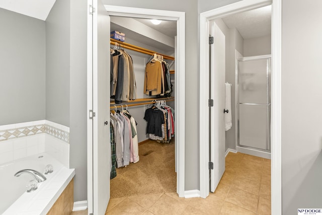 17310 I St, Omaha, NE 68135 - full bath with a spacious closet, a shower stall, a bath, tile patterned flooring, and baseboards