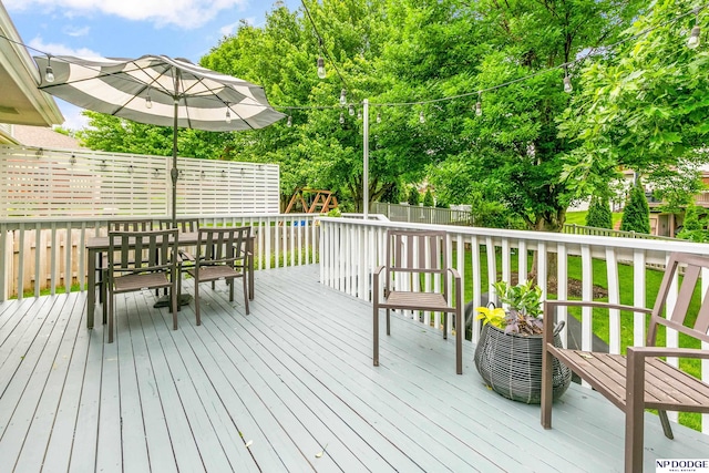 17310 I St, Omaha, NE 68135 - deck featuring a fenced backyard, a playground, and outdoor dining area