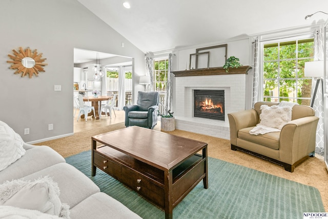 17310 I St, Omaha, NE 68135 - living room featuring a fireplace, carpet floors, baseboards, and high vaulted ceiling