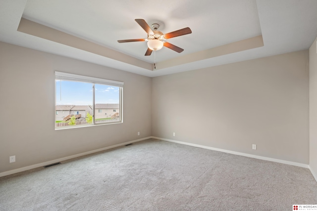 7775 N 149th St, Bennington, NE 68007 - carpeted empty room featuring a raised ceiling, a ceiling fan, and baseboards