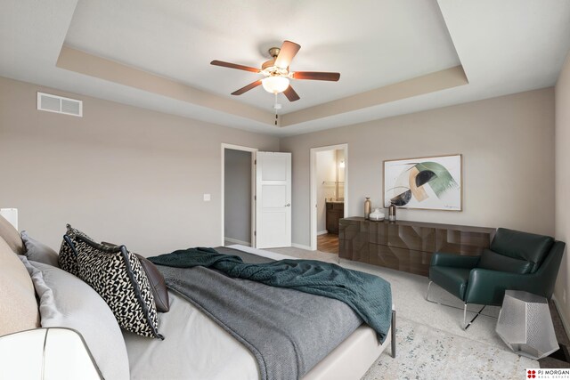 7775 N 149th St, Bennington, NE 68007 - bedroom with a tray ceiling, baseboards, a ceiling fan, and connected bathroom