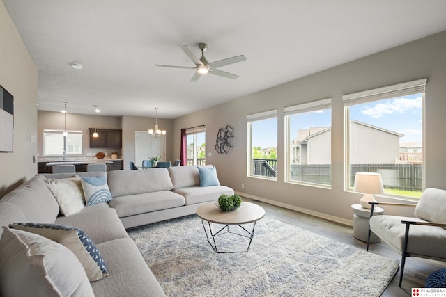 7775 N 149th St, Bennington, NE 68007 - living area with a chandelier, ceiling fan, wood finished floors, and baseboards