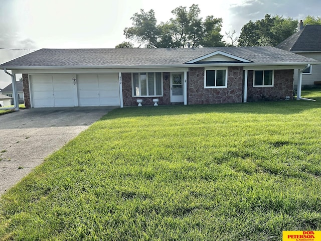 802 Main St, Bancroft, NE 68004 - view of front facade with a garage, driveway, a front lawn, and stone siding