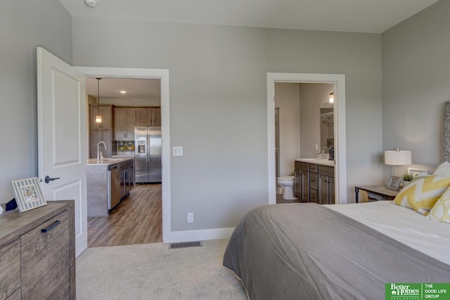 8105 S 177th St, Omaha, NE 68136 - bedroom featuring stainless steel fridge, baseboards, ensuite bathroom, recessed lighting, and light colored carpet