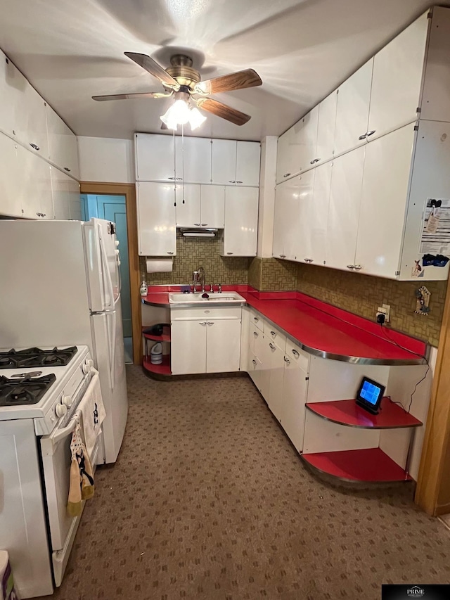 2031 N 49th St, Omaha, NE 68104 - kitchen featuring gas range gas stove, white cabinetry, ceiling fan, and decorative backsplash