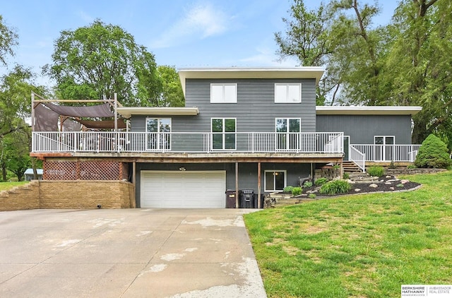 18640 Cathy Ln, Council Bluffs, IA 51503 - back of property featuring a wooden deck, a garage, driveway, and a lawn
