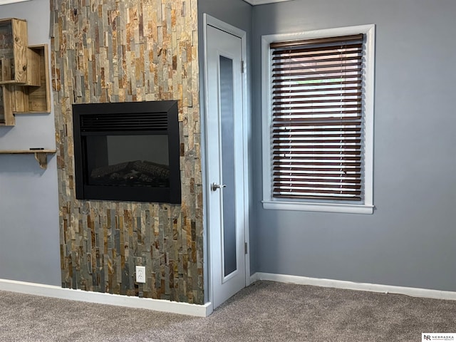 3836 Drexel St, Omaha, NE 68107 - detailed view of carpet flooring, baseboards, and a glass covered fireplace
