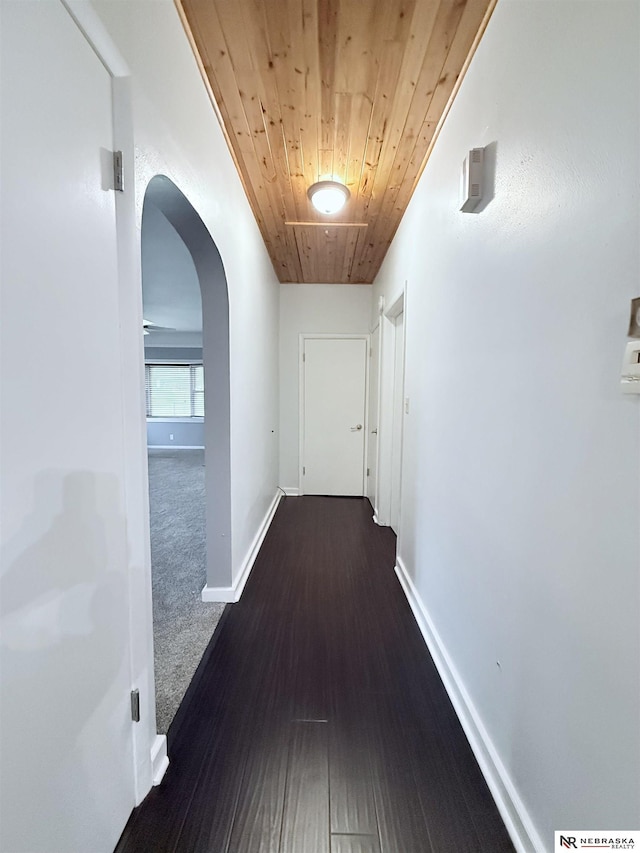 3836 Drexel St, Omaha, NE 68107 - hall featuring arched walkways, wooden ceiling, baseboards, wood finished floors, and carpet floors