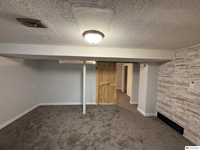3836 Drexel St, Omaha, NE 68107 - finished below grade area featuring dark carpet, baseboards, and a textured ceiling