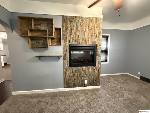 3836 Drexel St, Omaha, NE 68107 - unfurnished living room featuring arched walkways, carpet, baseboards, a fireplace, and ceiling fan