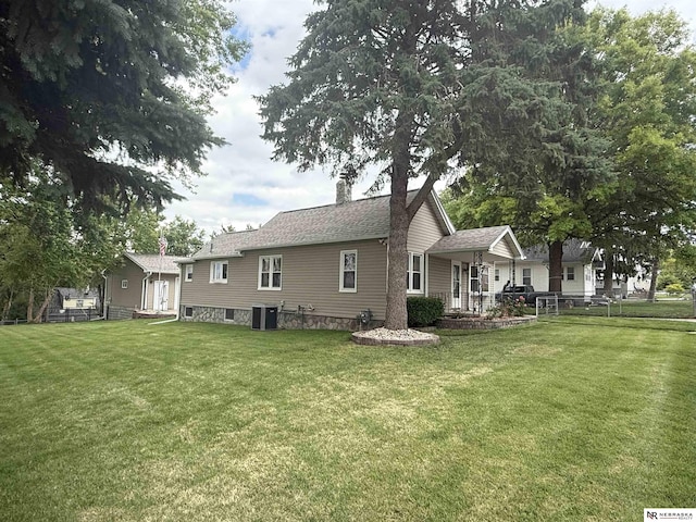 3836 Drexel St, Omaha, NE 68107 - rear view of property with a lawn, central air condition unit, a chimney, and a porch