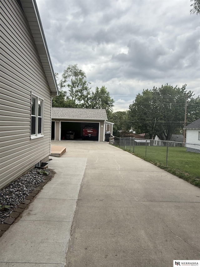 3836 Drexel St, Omaha, NE 68107 - view of patio / terrace featuring a garage and driveway