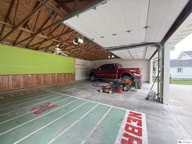 3836 Drexel St, Omaha, NE 68107 - garage with a garage door opener, a wainscoted wall, and wooden walls