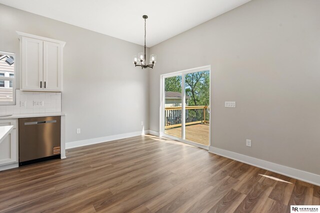 1713 M St, Tekamah, NE 68061 - unfurnished dining area featuring dark wood finished floors, a chandelier, and baseboards