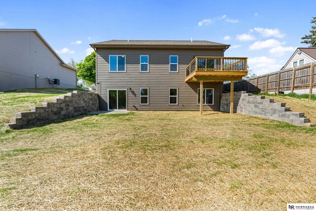 1713 M St, Tekamah, NE 68061 - rear view of house with a yard and a wooden deck