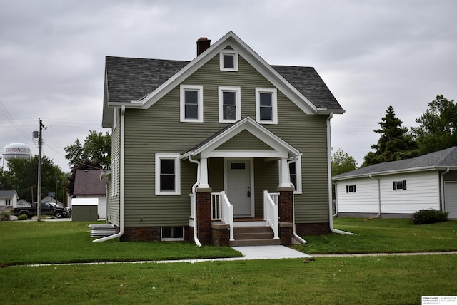116 8th St, Scribner, NE 68057 - view of front of home featuring a chimney, a front yard, and roof with shingles