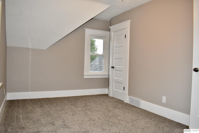 116 8th St, Scribner, NE 68057 - additional living space with carpet, baseboards, and vaulted ceiling