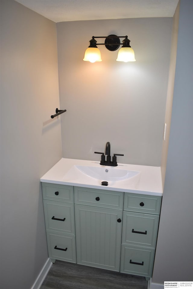 116 8th St, Scribner, NE 68057 - bathroom featuring vanity, wood finished floors, and baseboards