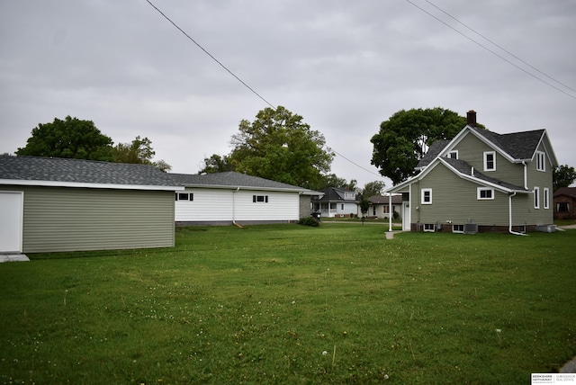 116 8th St, Scribner, NE 68057 - view of green lawn featuring central air condition unit and an outbuilding