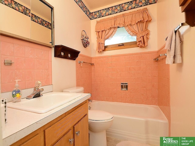 1609 N 71st St, Lincoln, NE 68505 - bathroom featuring toilet, tile walls, vanity, and wainscoting