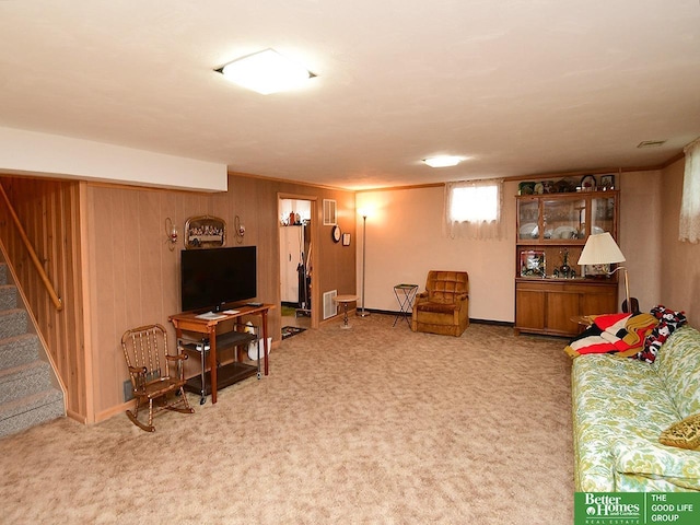 1609 N 71st St, Lincoln, NE 68505 - living area with stairway, carpet, and wood walls