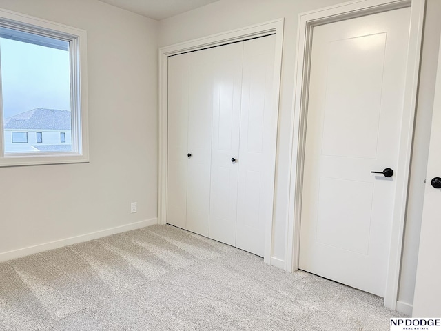 17010 Daniel St, Bennington, NE 68007 - unfurnished bedroom featuring carpet floors, baseboards, and a closet