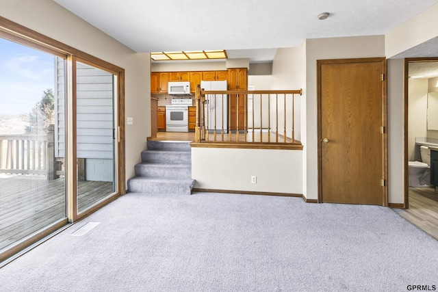 10103 S 11th St, Bellevue, NE 68123 - unfurnished living room featuring light carpet, stairs, and baseboards