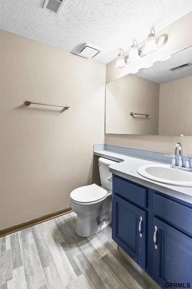 10103 S 11th St, Bellevue, NE 68123 - bathroom with toilet, vanity, wood finished floors, and a textured ceiling