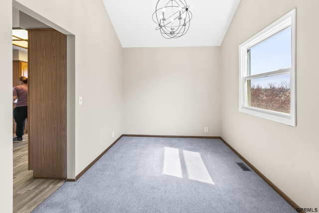 10103 S 11th St, Bellevue, NE 68123 - carpeted spare room with vaulted ceiling, a chandelier, and baseboards