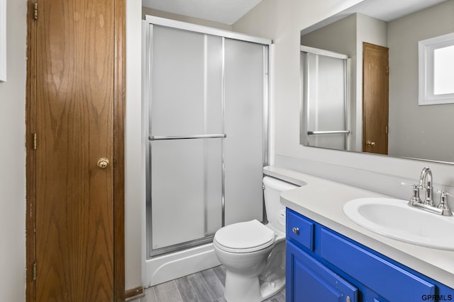 10103 S 11th St, Bellevue, NE 68123 - bathroom featuring a shower stall, vanity, toilet, and wood finished floors