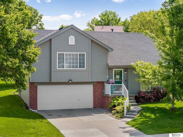 3015 N 144th Ter, Omaha, NE 68116 - tri-level home featuring roof with shingles, a garage, a front yard, and concrete driveway