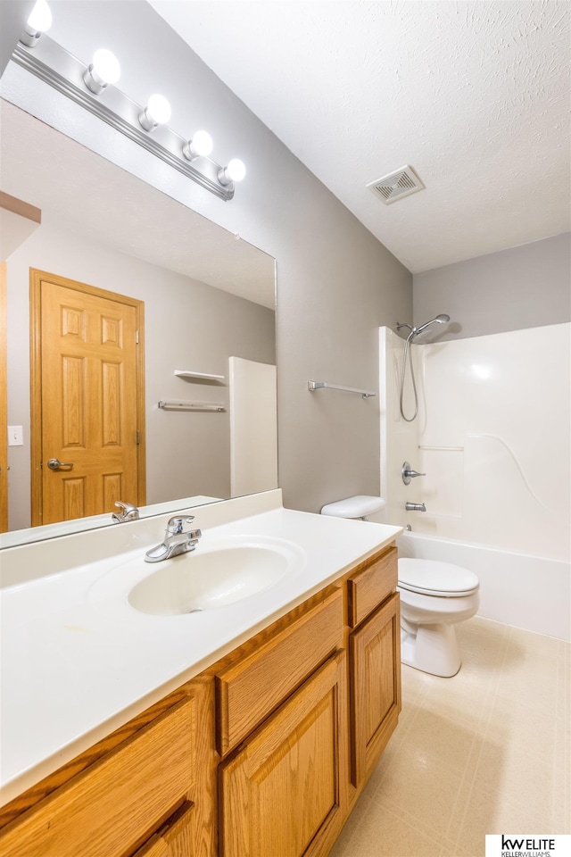 3015 N 144th Ter, Omaha, NE 68116 - bathroom featuring toilet, vanity, bathing tub / shower combination, and a textured ceiling