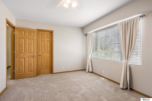 3015 N 144th Ter, Omaha, NE 68116 - unfurnished bedroom with carpet floors, baseboards, and ceiling fan