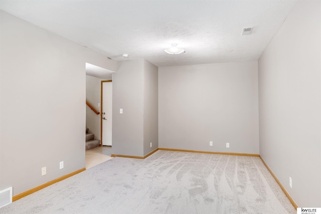 3015 N 144th Ter, Omaha, NE 68116 - carpeted empty room with stairway, baseboards, and a textured ceiling