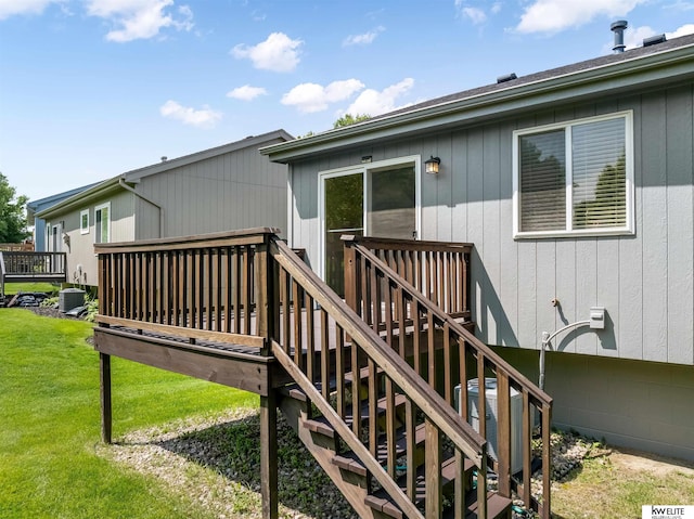 3015 N 144th Ter, Omaha, NE 68116 - wooden deck featuring a lawn, stairway, and central AC