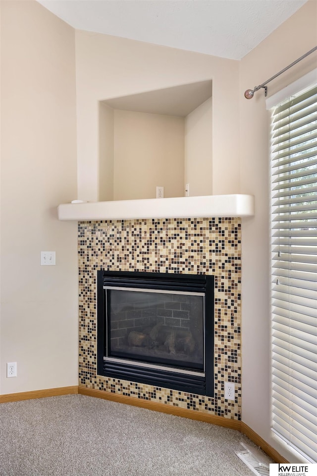 3015 N 144th Ter, Omaha, NE 68116 - detailed view of carpet flooring, a glass covered fireplace, and baseboards
